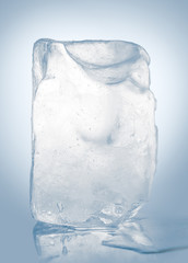 Chrystal clear melting natural ice block in cold light blue tones on mirror surface. Clipping path...