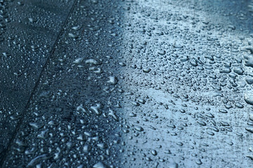 drops of water on a metallic shiny surface