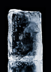 Crystal clear, textured, natural ice block, on  black background. Clipping path included.