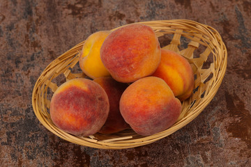 Peach heap in the wooden basket