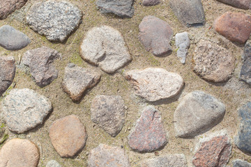 texture, background. The pavement of granite stone. Old cobblestone road pavement texture