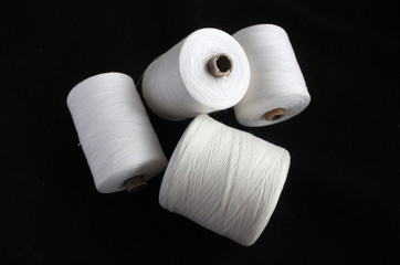 spools of thread on a black background