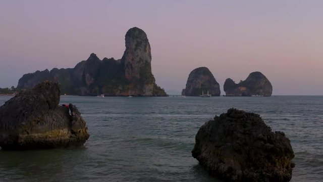 drone shot between rock in the ocean in Thailand, sunset