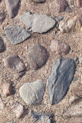 texture, background. The pavement of granite stone. Old cobblestone road pavement texture