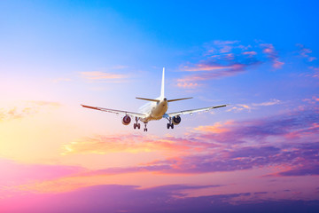 Fototapeta na wymiar Commercial airplane flying in beautiful sky at sunset,travel concept.