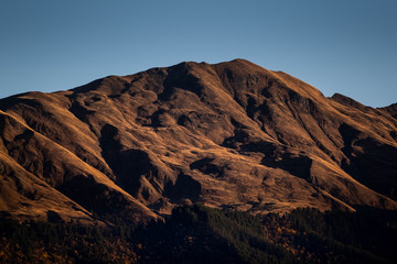 A mountain is lit by the setting sun in the Tusheti region.