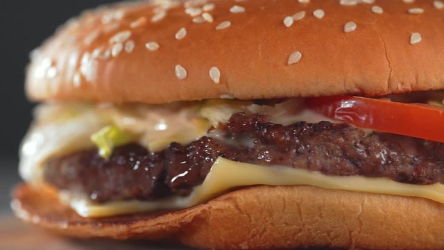 Fresh tasty burger or hamburger with juicy beef meat, cheese and vegetables, horizontal macro panoramic shot