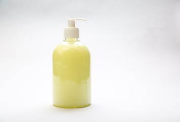 plastic bottle of yellow antiseptic soap with dispenser on a white background