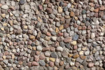 Stone wall texture, road made of small round stones