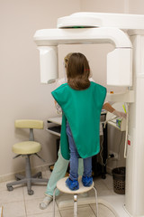 medicine, dentistry and healthcare concept.   x-ray machine scanning  kid patient teeth at dental clinic 