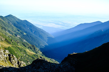 Fototapeta na wymiar Sunrise on Fagaras high mountain ridge. Romanian mountain landscape with high peaks over 2200m