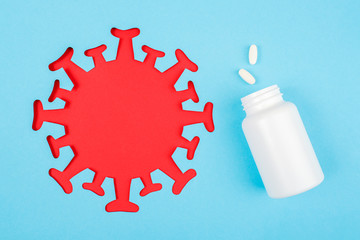 Two pills fly out from medical bottle. Dietary supplements, antibiotic, painkillers and red...