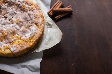 Homemade apple pie dessert on dark wooden table, copy space.