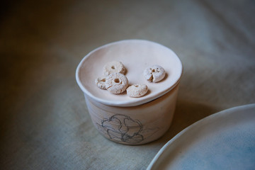 Golitsyno, Kaluga, Russia-may 18, 2019. Clay blanks for children's creativity at the master class in eco-Park. Layout on the table of clay vessels, plates, buttons