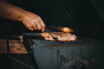 grilling beef on the barbecue.