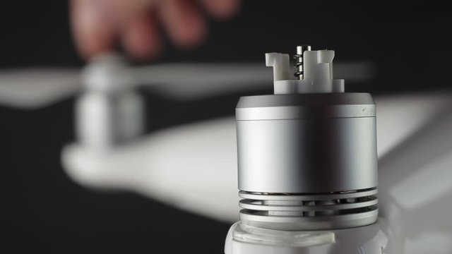 Macro shot brushless motor. Preparing a drone before flight, installing propellers.