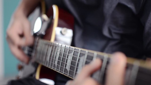 man playing electric guitar, hand close-up, music and sound.