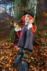 Mad Hatter sitting under a tree
