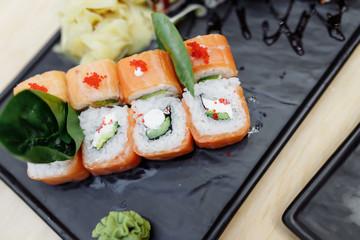 On table sushi roll food fish philadelphia japanese salmon delicious sushi rice cucumber meal traditional wasabi fresh healthy gourmet raw cuisine