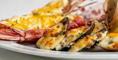 An assortment of baked seafood with cream and cheese