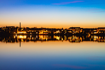 A beutiful water reflection of the city of Skanderborg in Denmark by night at a lake