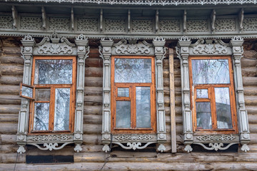 Fototapeta na wymiar Old Windows with carved architraves