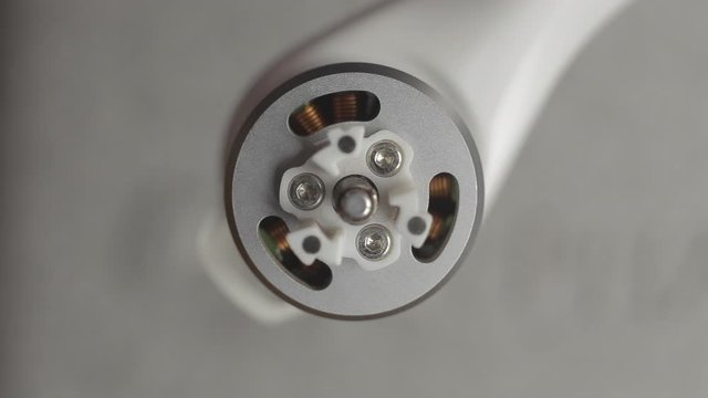Macro shot top down brushless motor. Preparing a drone before flight, installing propellers.