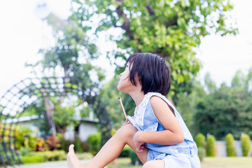Happy cute child girl on the blur green background.