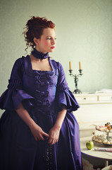 A gorgeous red-haired lady in a 18th century historical dress