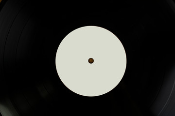 Close up shot of a black vinyl disk with white tag for mockup purposes