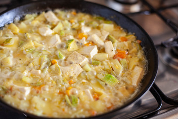 Tofu with vegetables in a pan.