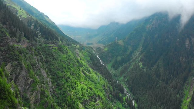 Romania. Fagaras mountain range. Mountain route Transfagarash. One of the most beautiful roads in the world. Popular tourist route. Drone. Aerial view. The camera moves forward