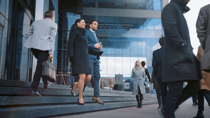 Diverse and Multicultural Office Managers and Business People Commute to Work in the Morning or from Office on a Sunny Day on Foot. Female and Male are Talking and Smiling on Their Way from Office. 