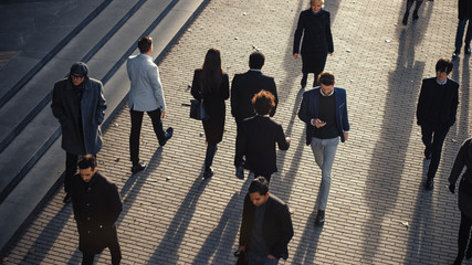 High Angle Shot of Office Managers and Business People Commuting to Work in the Morning or from Office on a Sunny Day on Foot. Pedestrians are Dressed Smartly. Successful People Holding Smartphones.