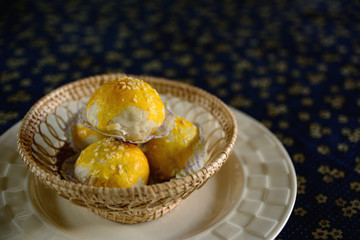 Chinese pastry in woven bamboo basket for tea time.