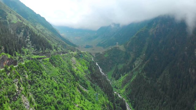 Romania. Fagaras mountain range. Mountain route Transfagarash. One of the most beautiful roads in the world. Popular tourist route. Drone. Aerial view. The camera moves up