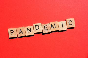 Pandemic, word in 3d wooden alphabet letters on bright red background