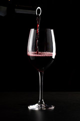red wine pouring into glass