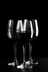 Red wine glasses on black background