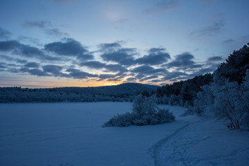 sunset over winter snow hills