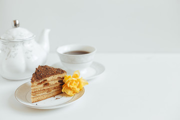 Slice of cake with cream on a white plate on a background in bright colors