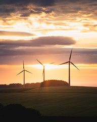 wind turbines at the sunset