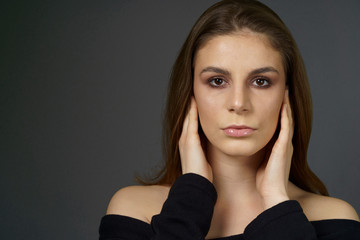 a young girl with smokey eyes and clear lip gloss make up