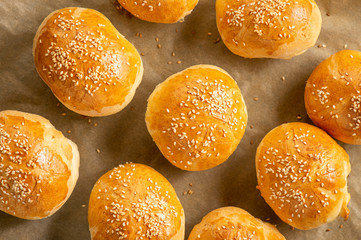 Homemade fresh bread buns with sesame seeds. - obrazy, fototapety, plakaty