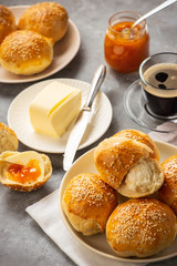 Homemade fresh buns served with butter and apricot jam.