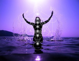 Celebrating life - Woman on the beach at sunset celebrating life with Sacred geometry Metatron's cube and 7 chakras