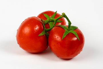 Tomatoes isolated on white. Tomato with drops. Full depth of field.