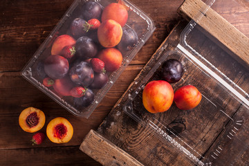 Peaches and nectarines in plastic containers