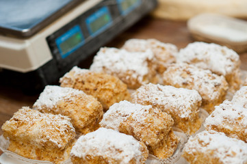 sweet cakes lie on the table against the background of measuring weights