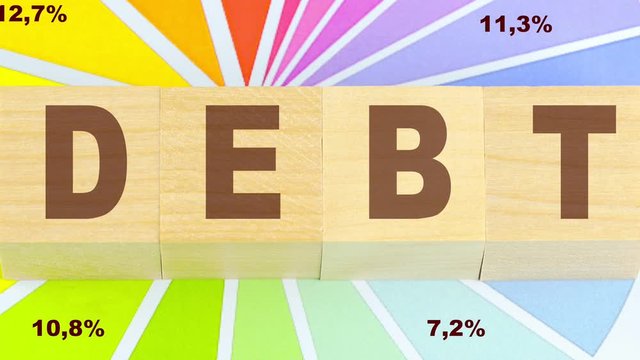 debt inscription on wooden blocks graphic background business concept zoom in animation